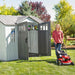 A woman standing in front of a Lifetime 10 Ft. X 8 Ft. Outdoor Storage Shed - 60243 shed.