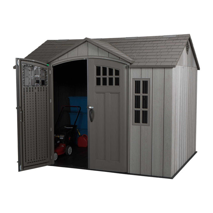 A Lifetime 10 Ft. X 8 Ft. Outdoor Storage Shed - 60330 with a door and a lawn mower.