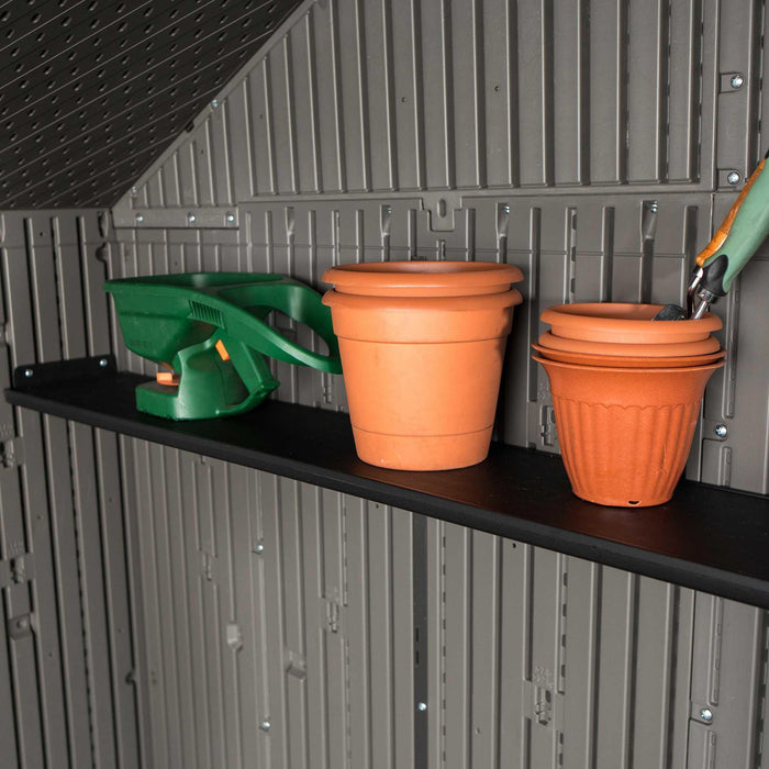 Two potted plants on a Lifetime 10 Ft. X 8 Ft. Outdoor Storage Shed - 60330 shelf in a Lifetime shed.