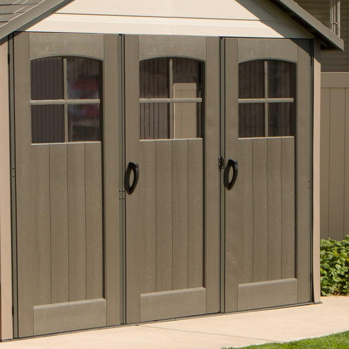 A Lifetime 11 Ft. X 21 Ft. Outdoor Storage Shed - 60237 in a backyard with two doors.