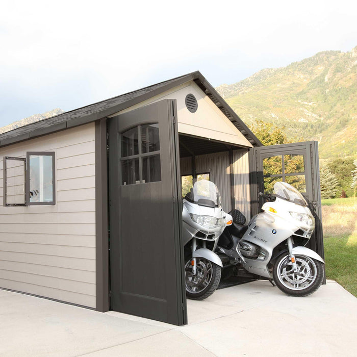 A Lifetime 11 Ft. X 21 Ft. Outdoor Storage Shed - 60237 is parked in front of a motorcycle.