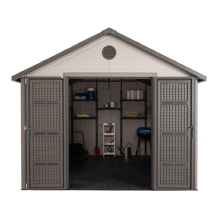 A Lifetime 11 Ft. X 13.5 Ft. Outdoor Storage Shed - 6415 with a door and shelves.