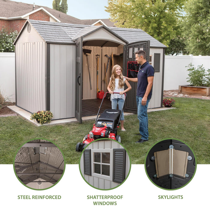 A man and woman are standing in front of a Lifetime 12.5 Ft. X 8 Ft. Outdoor Storage Shed - 60223.