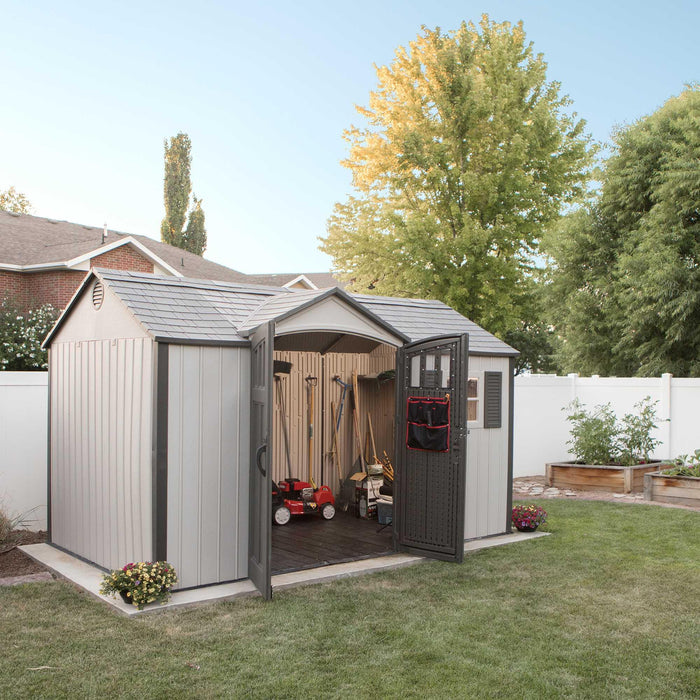 A backyard with a Lifetime 12.5 Ft. X 8 Ft. Outdoor Storage Shed - 60223 shed.