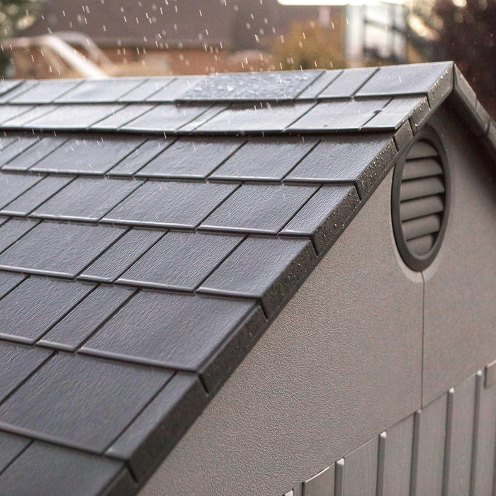 The roof of a Lifetime 12.5 Ft. X 8 Ft. Outdoor Storage Shed - 60223 is covered in rain.