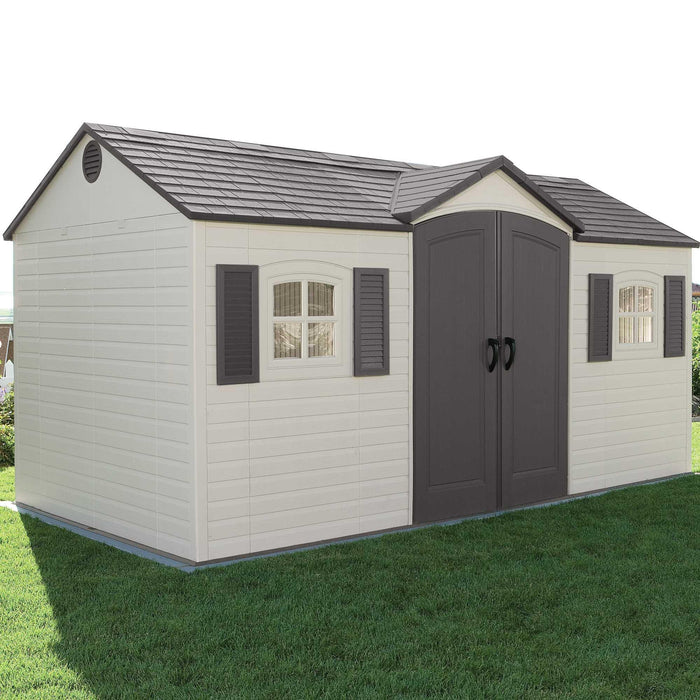 A Lifetime 15 Ft. X 8 Ft. Outdoor Storage Shed - 6446 in a grassy area.