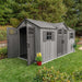 A Lifetime 15 Ft X 8 Ft Outdoor Storage Shed - 60318 in a backyard.
