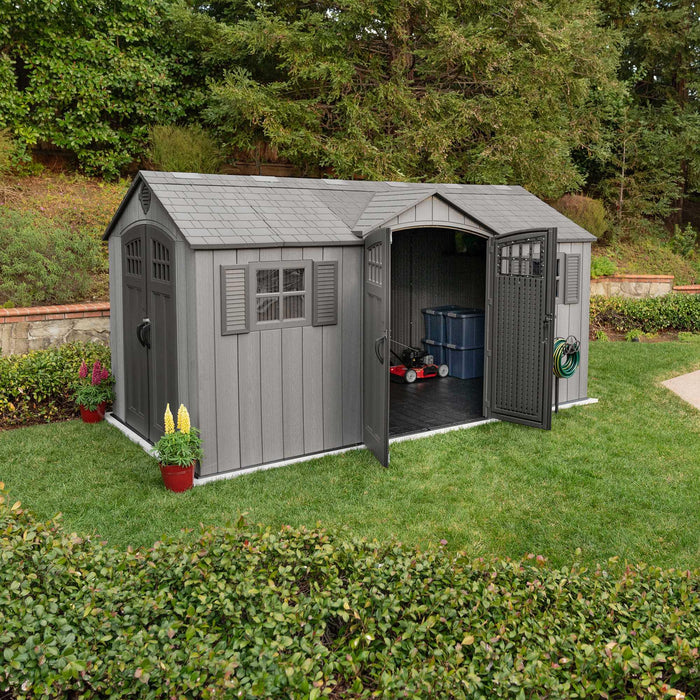 A Lifetime 15 Ft X 8 Ft Outdoor Storage Shed - 60318 in a backyard.