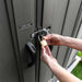 A person unlocking a door with a Lifetime 15 Ft X 8 Ft Outdoor Storage Shed - 60318 padlock.