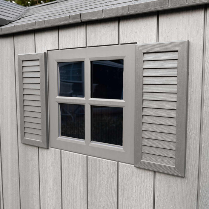 A Lifetime 15 Ft X 8 Ft Outdoor Storage Shed - 60318 with a window and shutters.