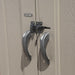 A closeup view of a pair of handles on a Lifetime 17.5 Ft. X 8 Ft. Outdoor Storage Shed - 60213 wooden door.