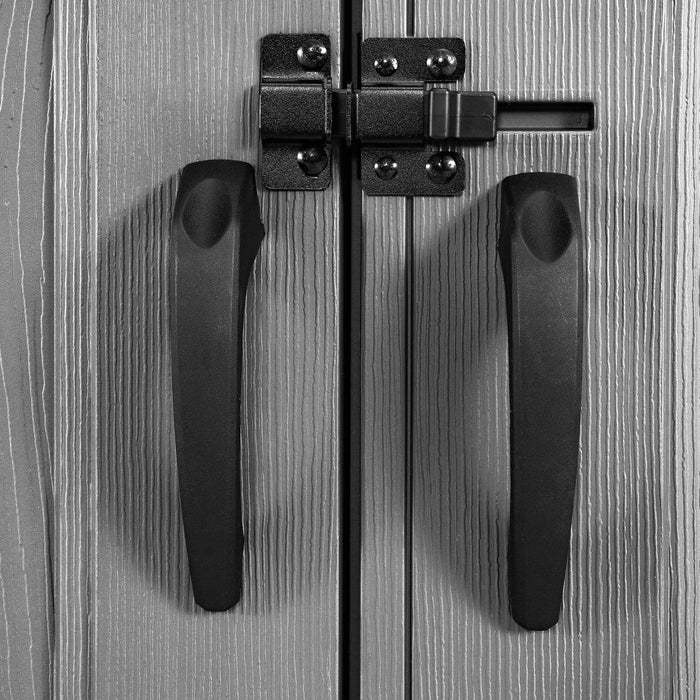 Closeup of two handles on a door of a shed, with a lock