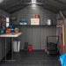 An interior view of a storage shed filled with items and tools