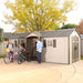 Three people interacting outside Storage Shed with dimensions of 20 Ft. x 8 Ft. 