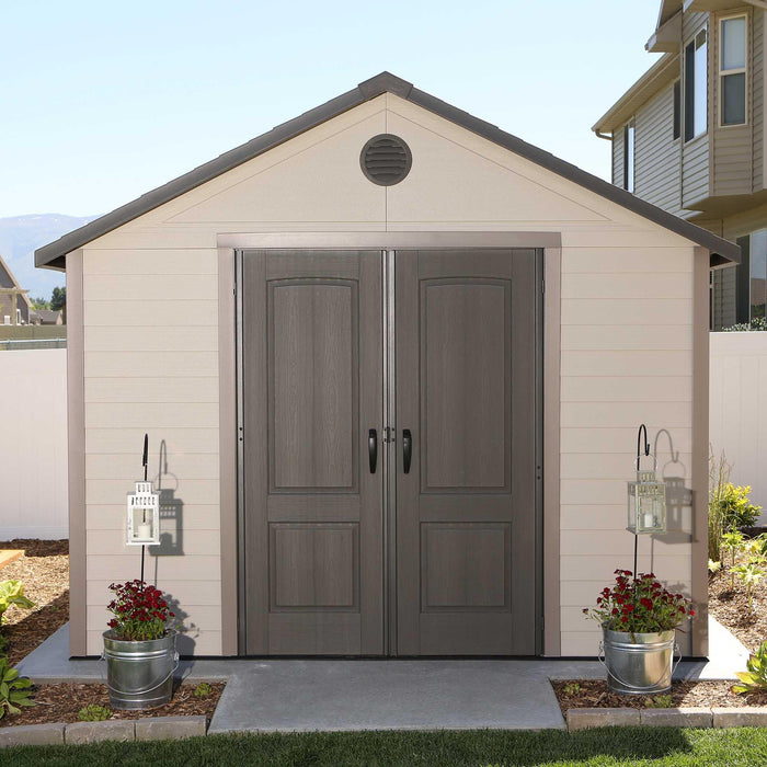 A Lifetime 11 Ft. X 13.5 Ft. Outdoor Storage Shed - 6415 with a gray door.