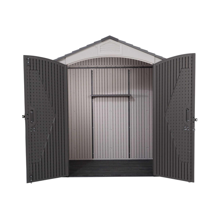 An empty interior view of a small shed with doors open on a white background.