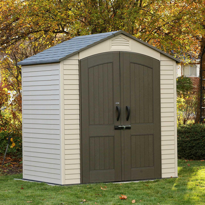 An Outdoor Storage Shed - placed in a yard with closed doors