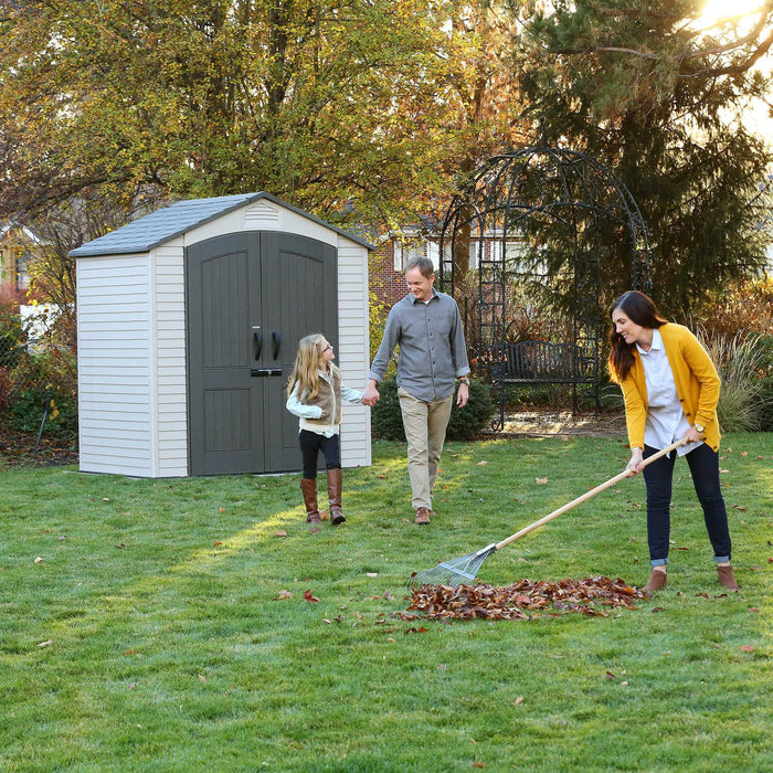 A family interacting by a 7 Ft. X 4.5 Ft. Outdoor Storage Shed 