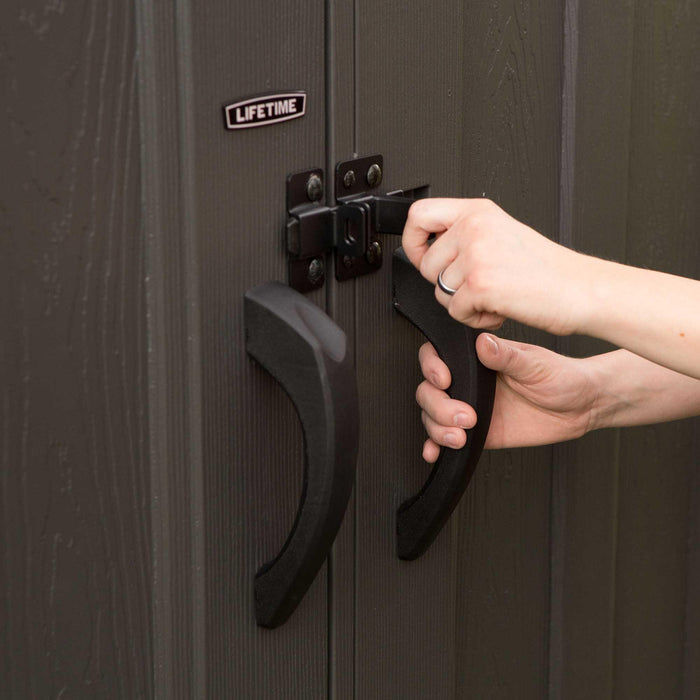 A person interacting with the door handle of a cabin 
