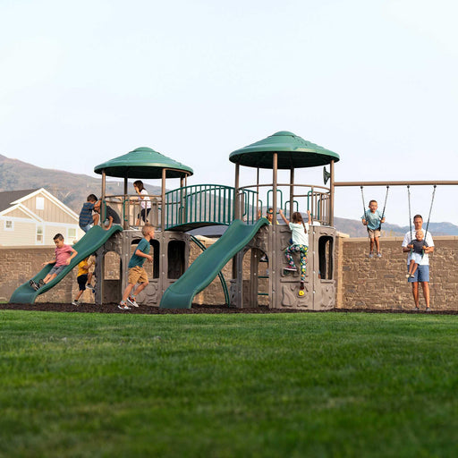 Full view of children playing on the Lifetime Double Adventure Tower With Monkey Bars in an outdoor setting.