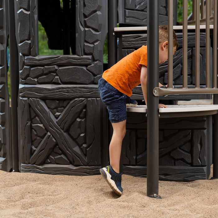 Child stepping into the tower entry of the Lifetime Adventure Castle playset.