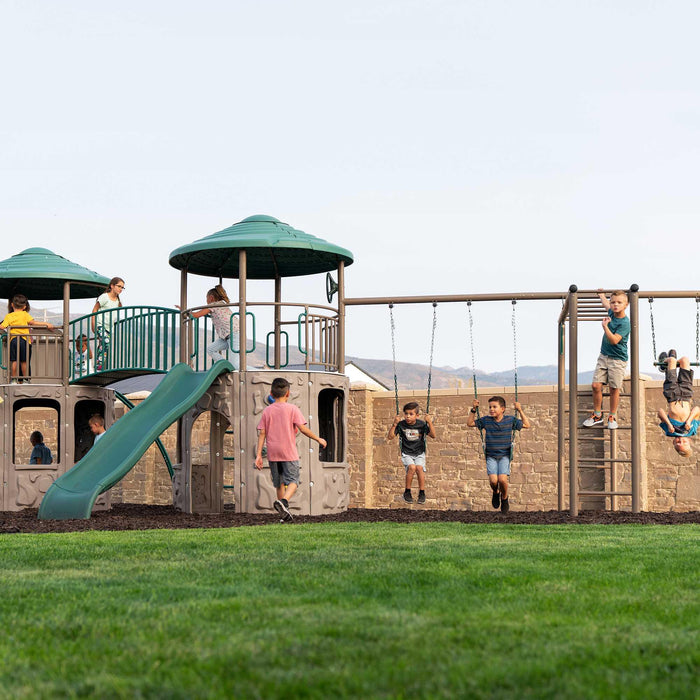 Children actively playing on the Lifetime Double Adventure Tower with Monkey Bars outdoors.