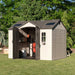 A small Lifetime 10 Ft. X 8 Ft. Outdoor Storage Shed - 60005 on a grassy area.