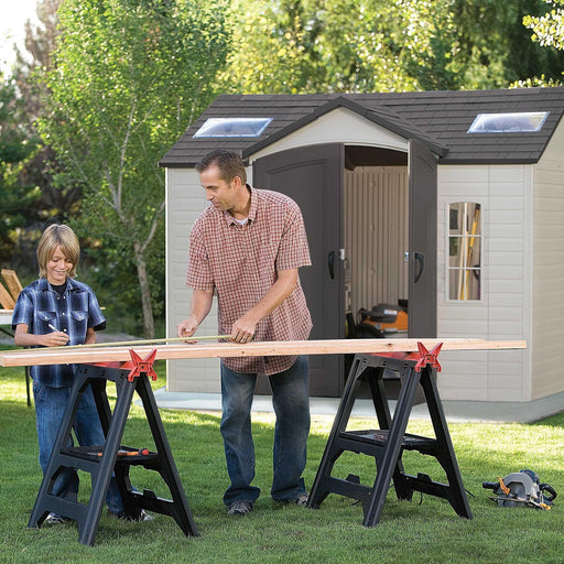 A man and a boy working on a Lifetime 10 Ft. X 8 Ft. Outdoor Storage Shed - 60005.