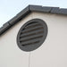 A round window on the side of a Lifetime 10 Ft. X 8 Ft. Outdoor Storage Shed - 60005.