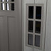 A close up of a Lifetime 10 Ft. X 8 Ft. Outdoor Storage Shed - 60330 grey door with a glass window.