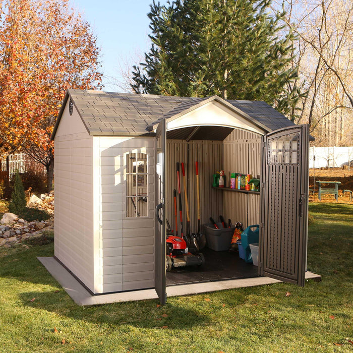 A Lifetime 10 Ft. X 8 Ft. Outdoor Storage Shed - 60333 in a grassy area.