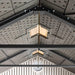 The Lifetime 10 Ft. X 8 Ft. Outdoor Storage Shed - 60333 is installed on the ceiling of a building with metal beams and lights.