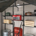 A Lifetime 11 Ft. X 18.5 Ft. Outdoor Storage Shed - 60355 with shelves and a red wheelbarrow.