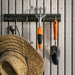A Lifetime 11 Ft. X 18.5 Ft. Outdoor Storage Shed - 60355, shovel, and other gardening tools are hanging on a wall.