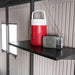 A Lifetime 11 Ft. X 18.5 Ft. Outdoor Storage Shed - 60355 with a radio and a water bottle.