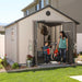 A woman and a child standing in front of a Lifetime 11 Ft. X 13.5 Ft. Outdoor Storage Shed - 6415.