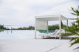 A Bon Pergola lounge chair next to a swimming pool.