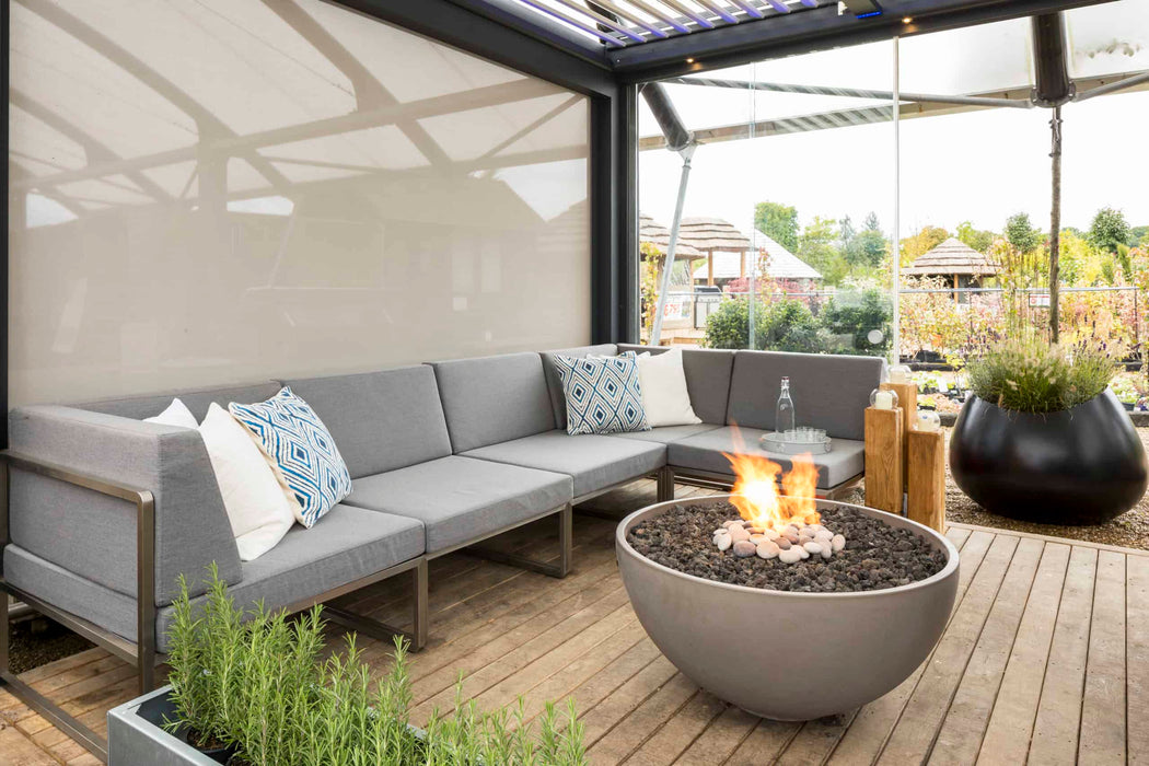 A comfortable outdoor seating area complemented by the warmth of a Solus Decor Hemi Firebowl, blending seamlessly with modern decor.