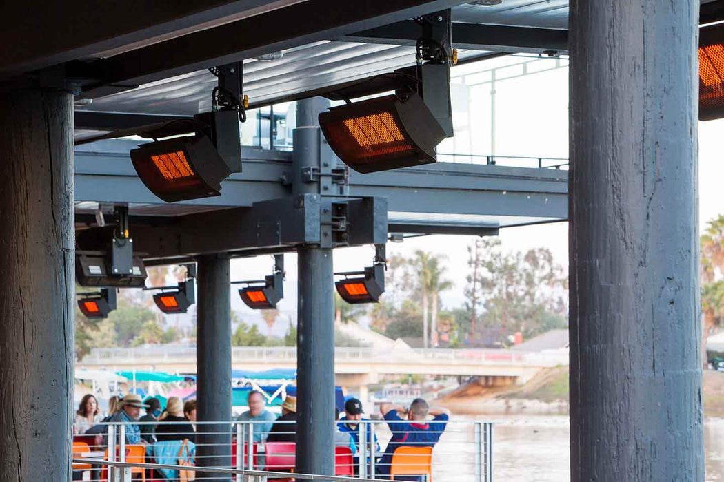 Bromic Tungsten Smart-Heat gas patio heaters installed at a waterside outdoor venue, providing warmth to patrons with a view.