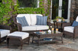An all-weather Tortuga Outdoor Sea Pines 6-Piece Loveseat Set - Java patio furniture set on a stone patio.