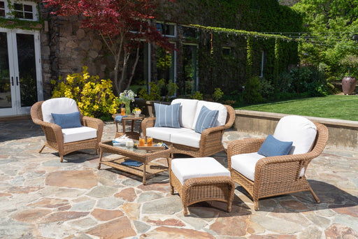 A patio with a Tortuga Outdoor Sea Pines 6-Piece Loveseat Set - Mojave.