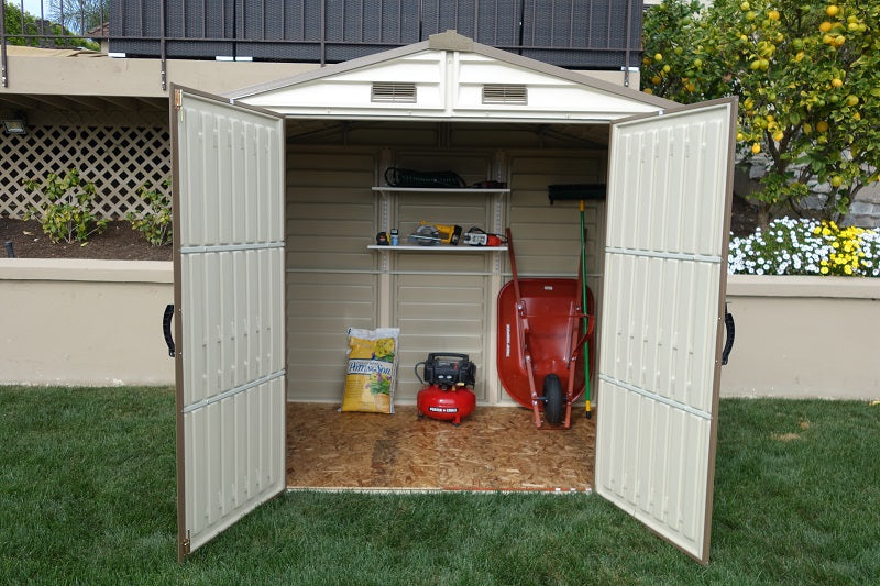 Open Duramax StoreAll 8'x6' Vinyl Shed filled with gardening tools and equipment, highlighting its practical use and capacity.