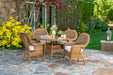 Tortuga Outdoor Sea Pines 5-Piece Outdoor Wicker Dining Set -  Mojave on a luxury retreat patio.