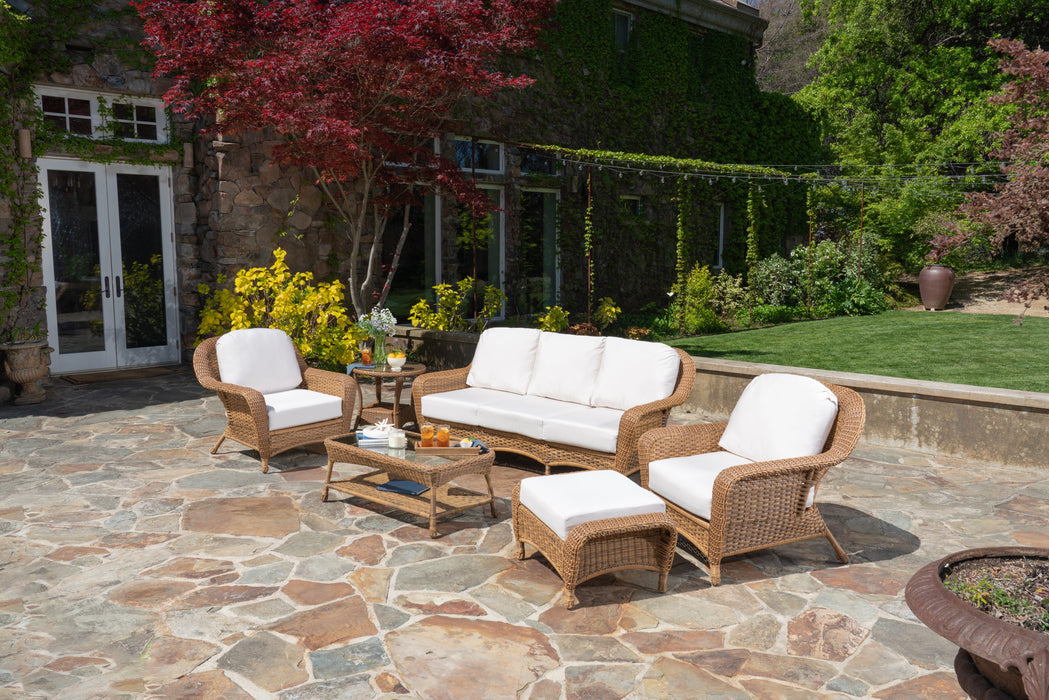 An outdoor living space with a Tortuga Outdoor Sea Pines 6-Piece Seating Set with Sofa - Mojave.