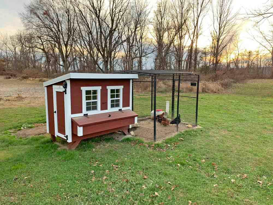 Classic red OverEZ Large Chicken Coop equipped with an extended chicken run, showing a harmonious outdoor setting during sunset.