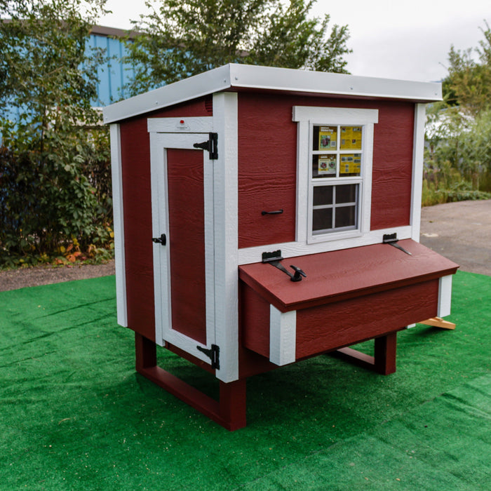 A vibrant red OverEZ Medium Chicken Coop with white trim and window, offering a spacious and comfortable home for poultry.