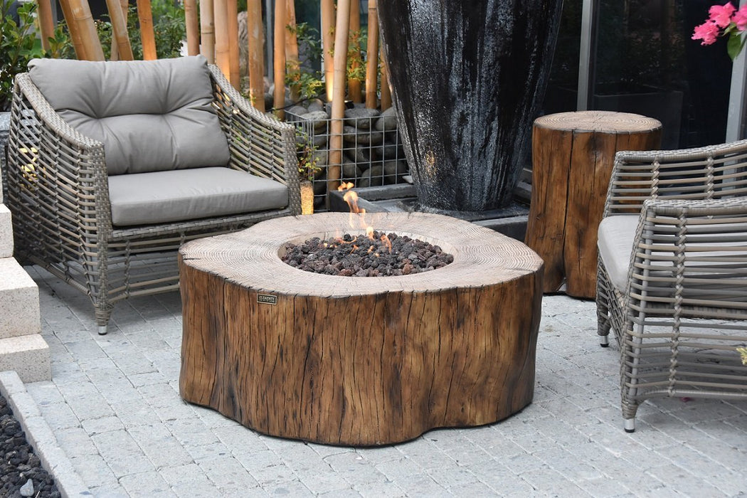 Elementi Manchester Fire Table - Redwood on a patio with chairs