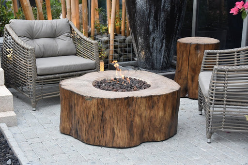 Elementi Manchester Fire Table - Redwood on a patio with chairs