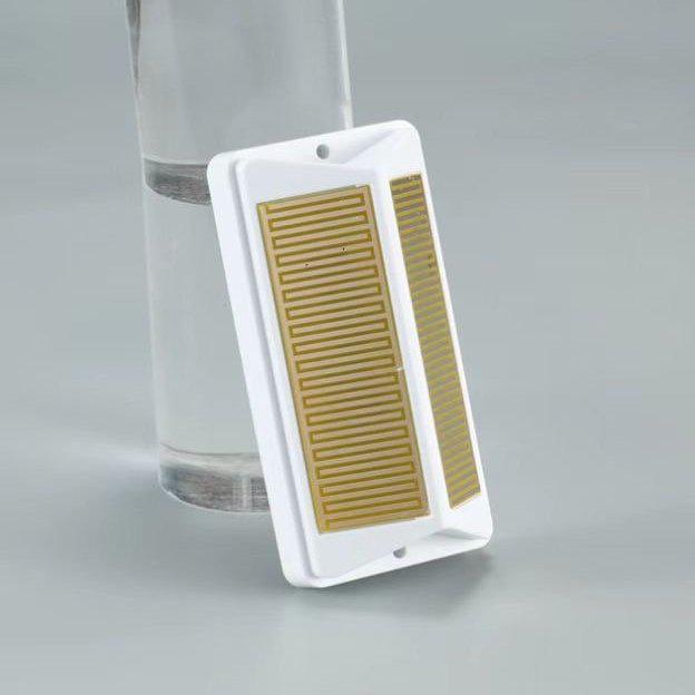 A Bon Pergola Rain Sensor for Villa Pergola - Add-Ons Only, sitting on top of a glass.