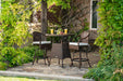 A durable Tortuga Outdoor Sea Pines 3-Piece Wicker Bar Set - Java or Mojave with a table and chairs.